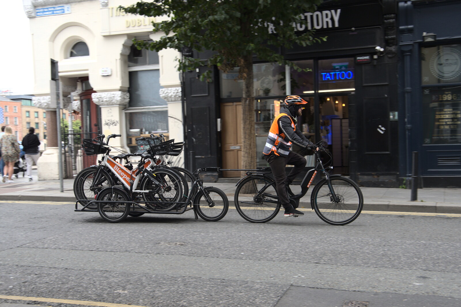 A cyclist with a trailer of bikes goes by from A Trip to Noddy's, and Dublin City Centre, Wicklow and Dublin, Ireland - 16th August 2021