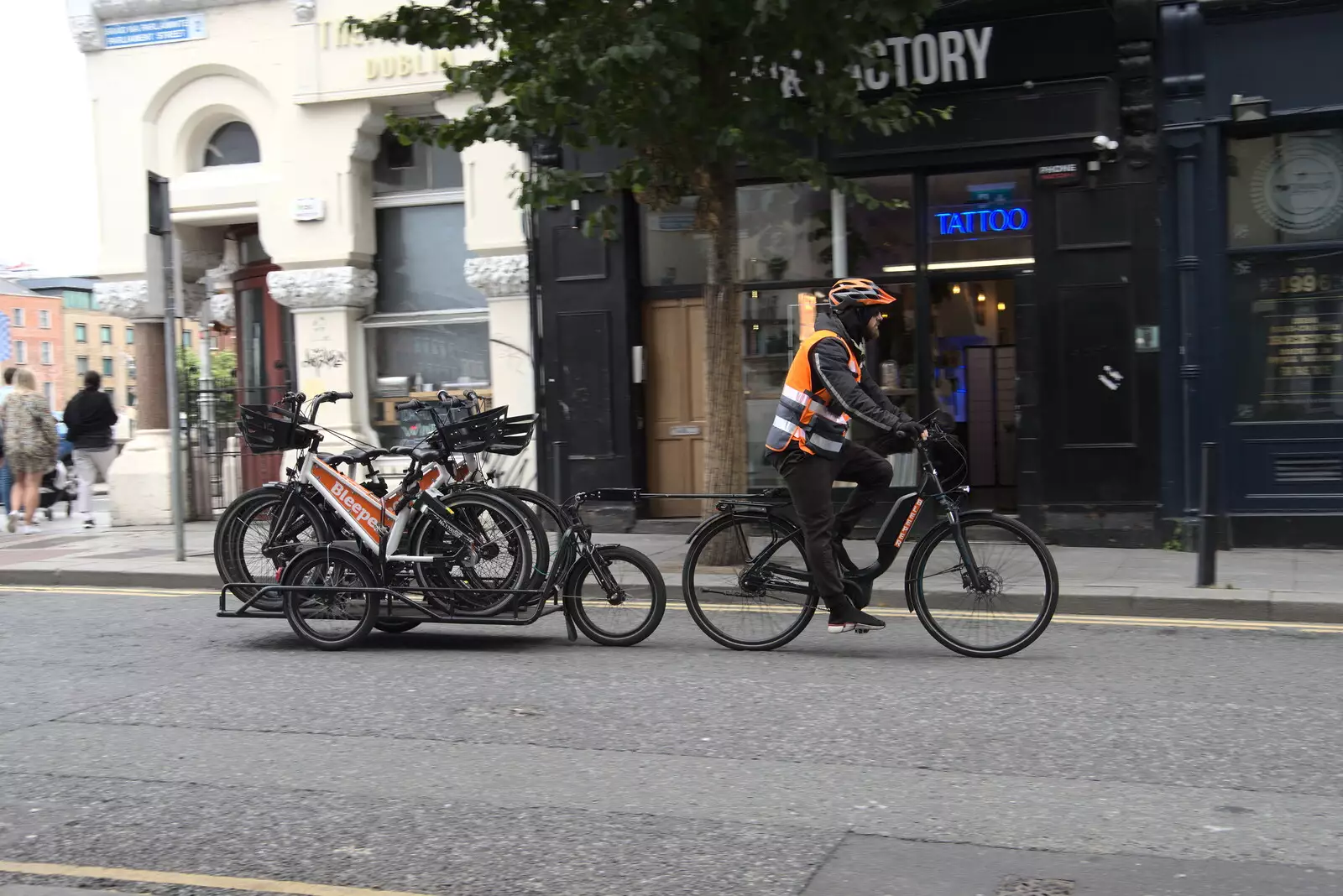 A cyclist with a trailer of bikes goes by, from A Trip to Noddy's, and Dublin City Centre, Wicklow and Dublin, Ireland - 16th August 2021