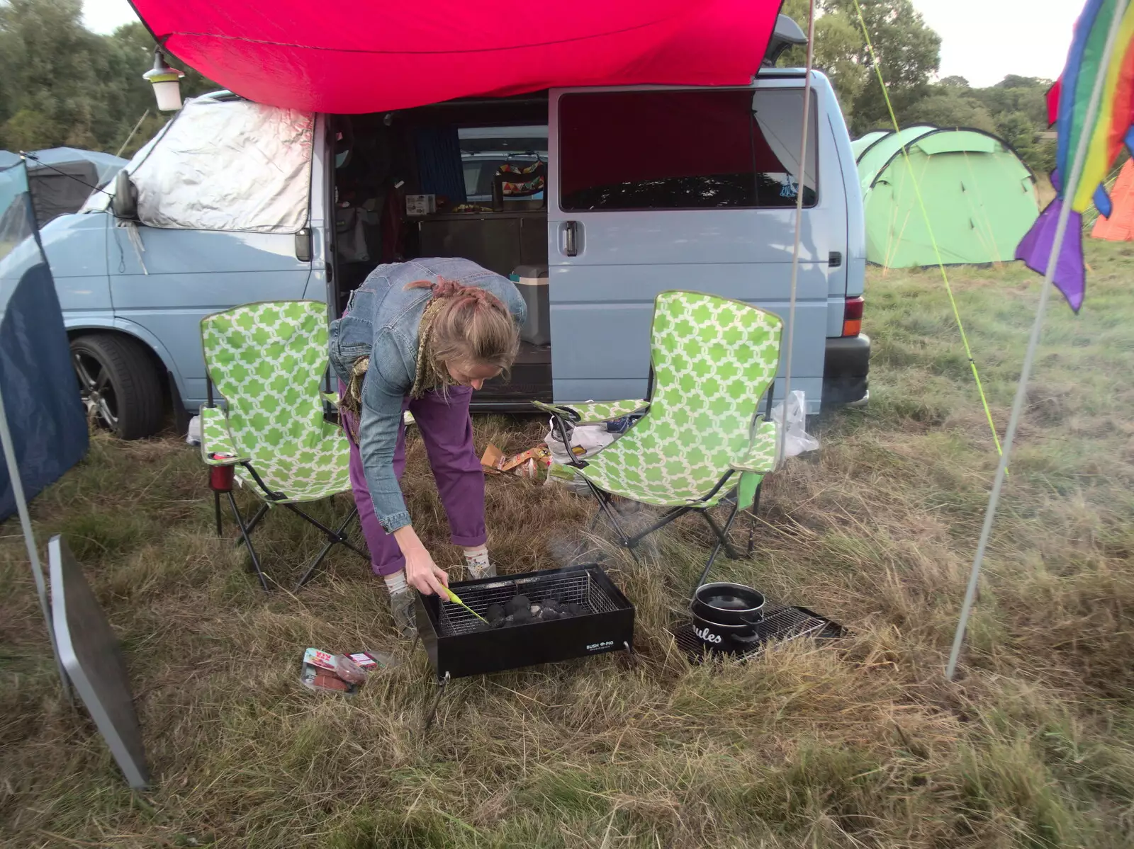 Allyson pokes around in a barbeque, from Maui Waui Festival, Hill Farm, Gressenhall, Norfolk - 28th August 2021