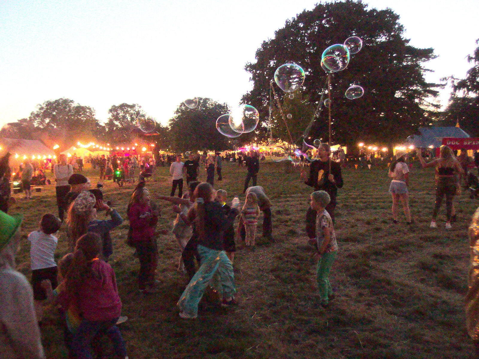Children chase bubbles around from Maui Waui Festival, Hill Farm, Gressenhall, Norfolk - 28th August 2021