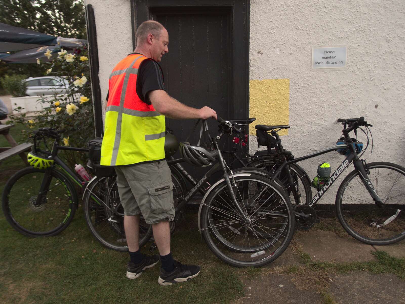 The Last Weavers Ever, Market Hill, Diss, Norfolk - 10th September 2021: Paul leans his bike on a wall at Thorndon
