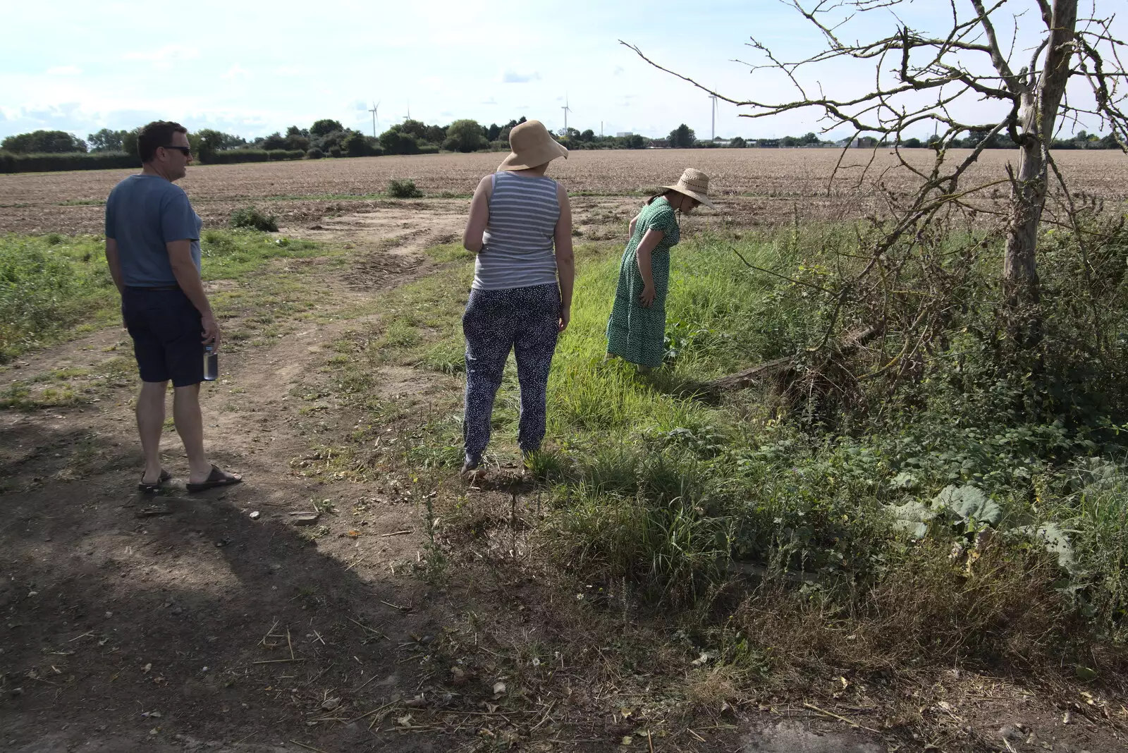 Suzanne looks for remains of the old village, from A Summer Party and an Airfield Walk with Clive, Brome, Suffolk - 11th September 2021