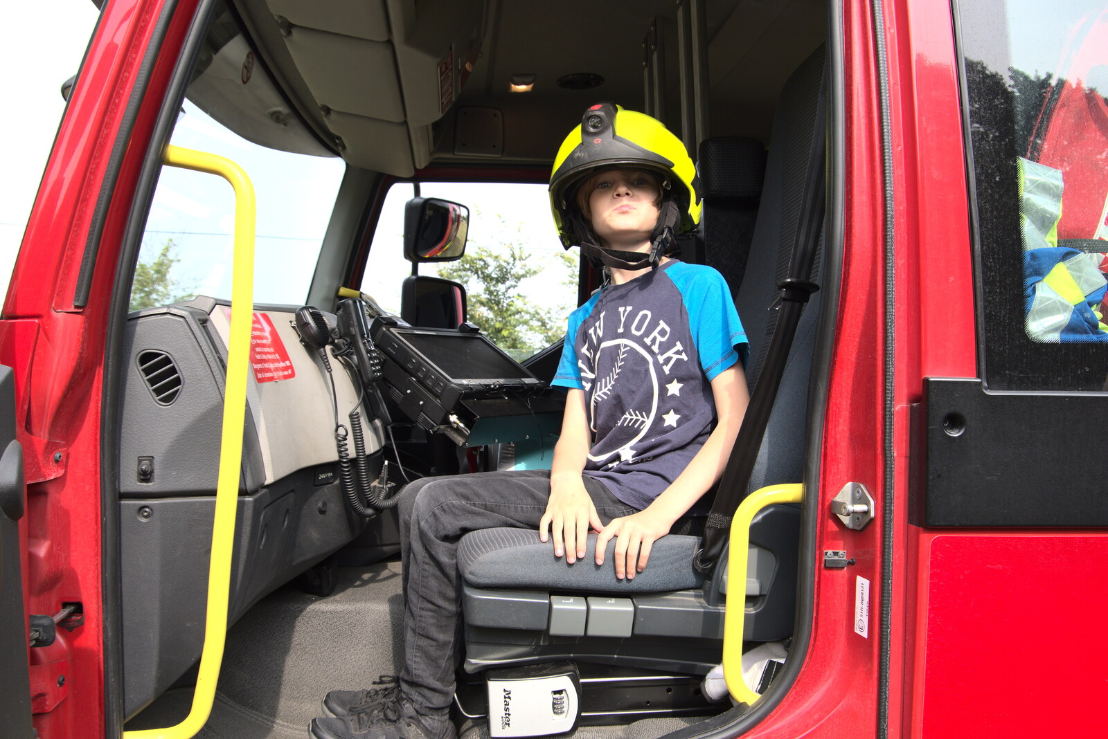 Harry has a go in the fire engine from The Brome and Oakley Fête, Oakley Hall, Suffolk - 19th September 2021