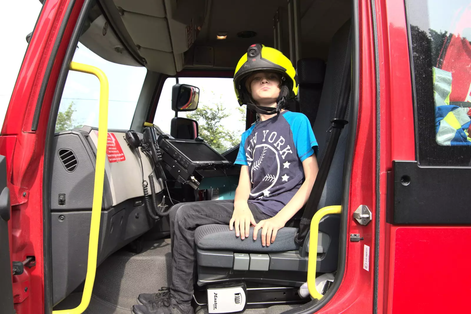 Harry has a go in the fire engine, from The Brome and Oakley Fête, Oakley Hall, Suffolk - 19th September 2021