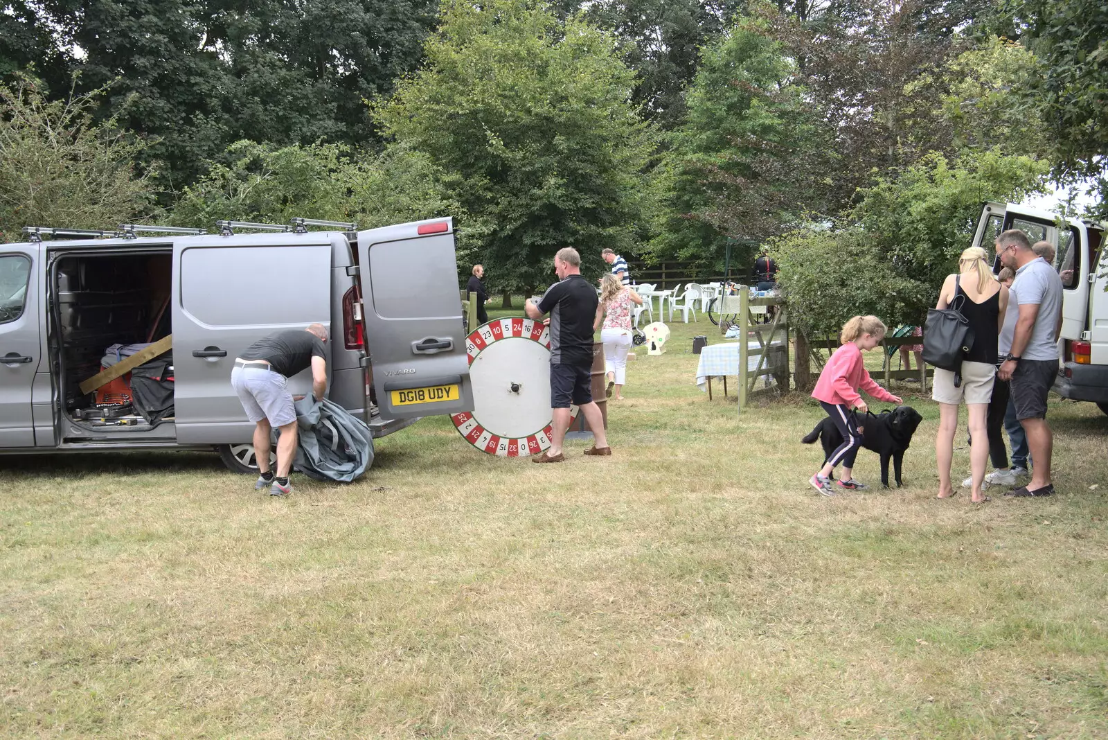 Andrew rolls away a roulette wheel, from The Brome and Oakley Fête, Oakley Hall, Suffolk - 19th September 2021