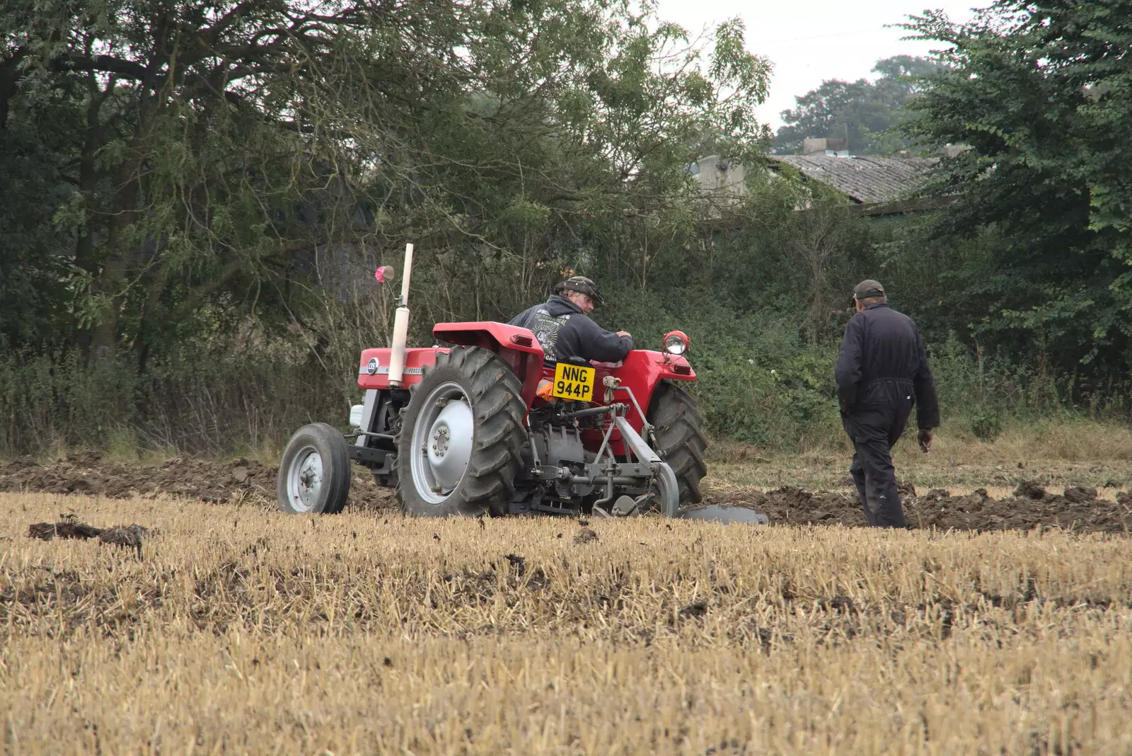 A tractor spins its wheels in the mud, from Vintage Tractor Ploughing, Thrandeston, Suffolk - 26th September 2021