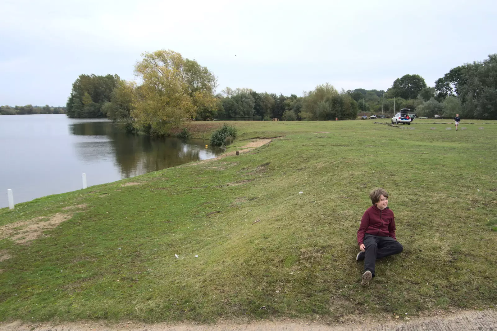 Fred sits on the bank of the lake, from A Trip to Weybread Sailing Club, Harleston, Norfolk - 17th October 2021