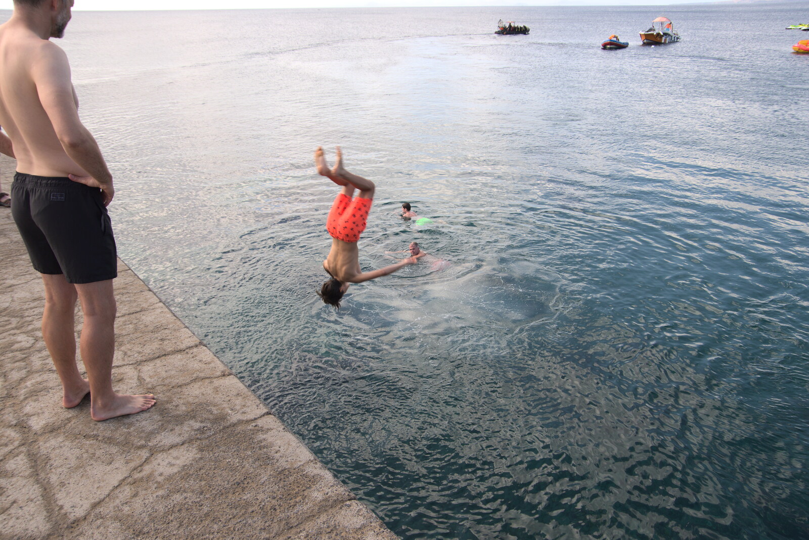 A boy hurls himself off the pier from Five Days in Lanzarote, Canary Islands, Spain - 24th October 2021