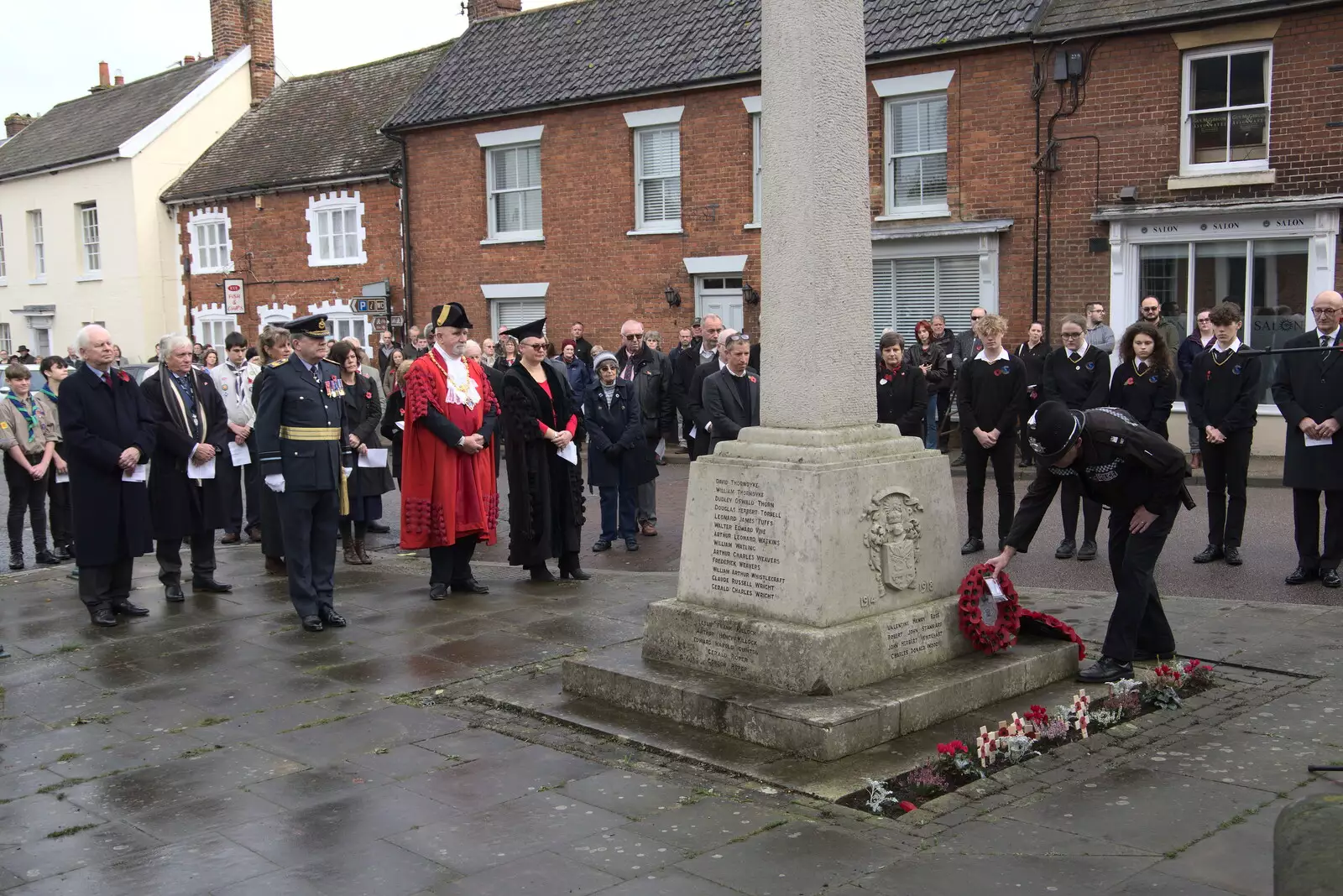 A policeman lays a wreath, from The GSB and Remembrance Day Parades, Eye and Botesdale, Suffolk - 14th November 2021