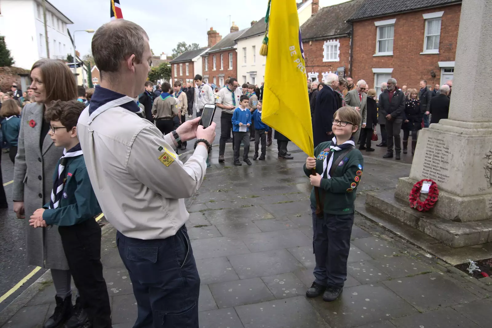 Andy gets a photo of the Cubs' flag bearer, from The GSB and Remembrance Day Parades, Eye and Botesdale, Suffolk - 14th November 2021