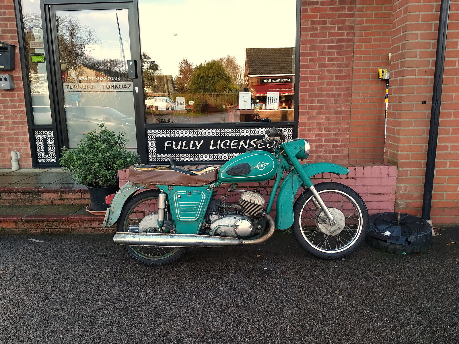 There's a cool old motorbike outside Turkuaz from Dove Players' Trouble in Pantoland, Eye Community Centre, Suffolk - 11th December 2021