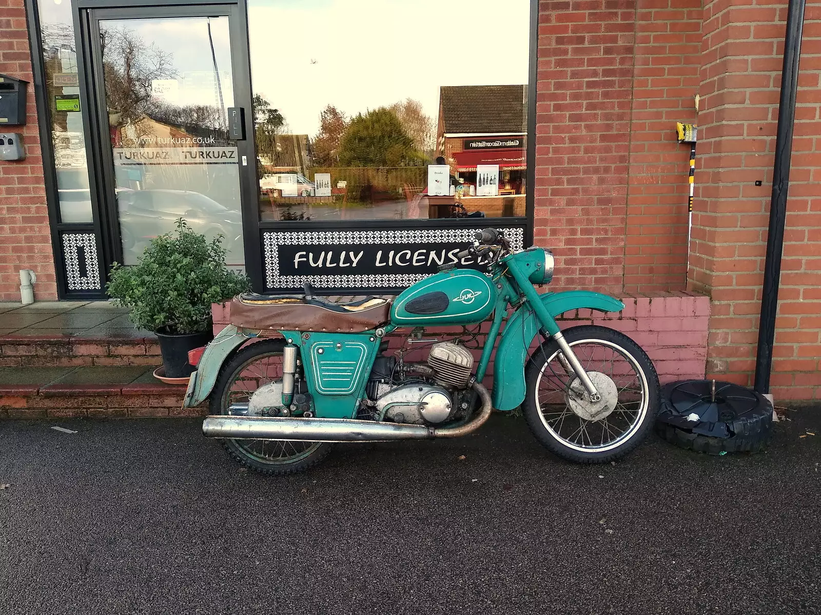 There's a cool old motorbike outside Turkuaz, from Dove Players' Trouble in Pantoland, Eye Community Centre, Suffolk - 11th December 2021