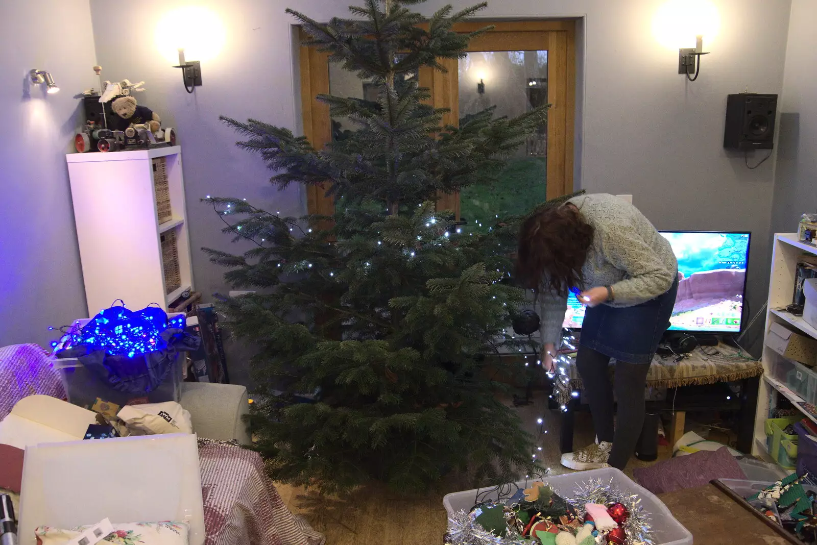 Isobel starts decorating the Christmas tree, from GSB Carols and Beer With the Lads, Thornham and Thorndon, Suffolk  - 18th December 2021