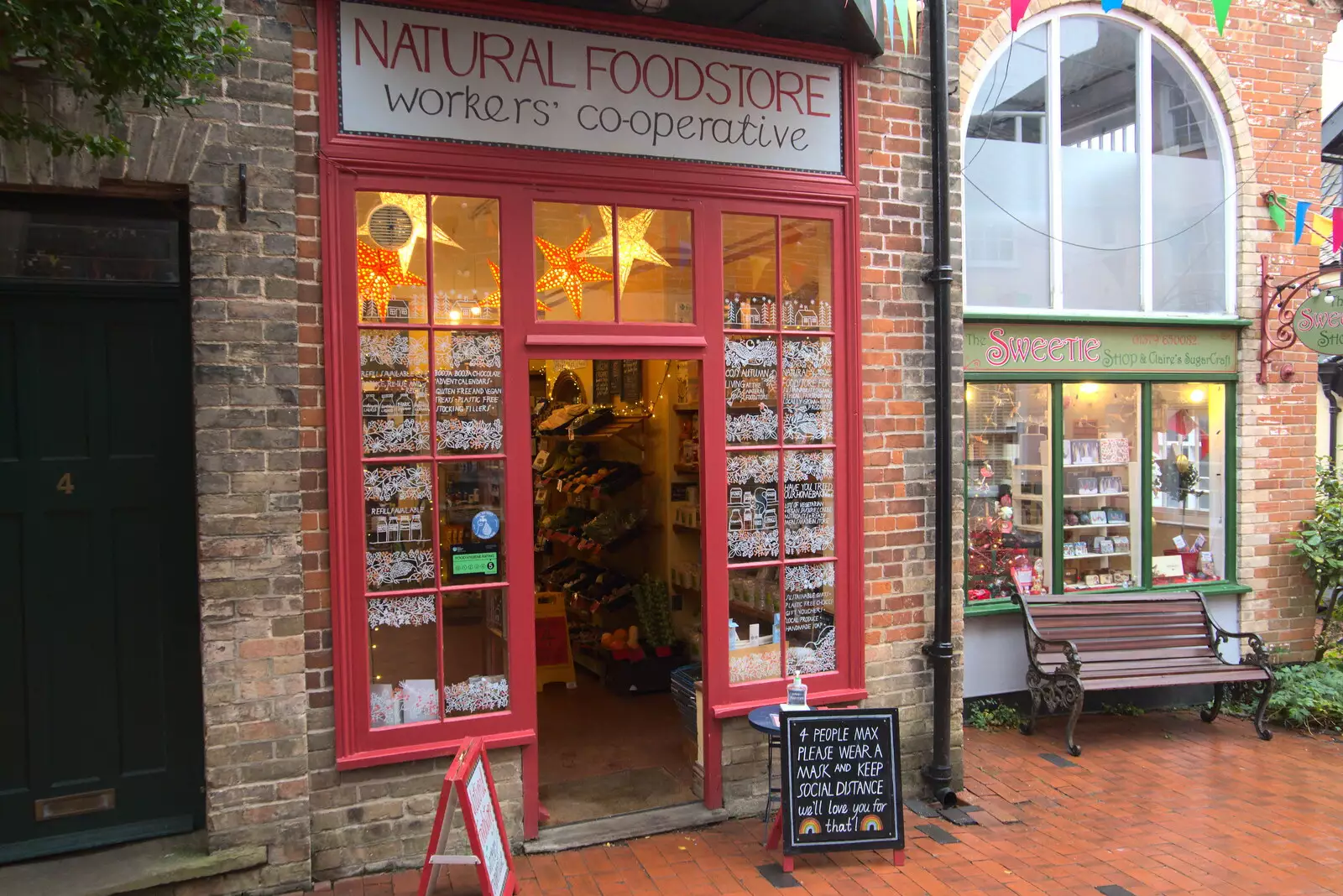 The glow of warm lights at the Natural Foodstore, from GSB Carols and Beer With the Lads, Thornham and Thorndon, Suffolk  - 18th December 2021