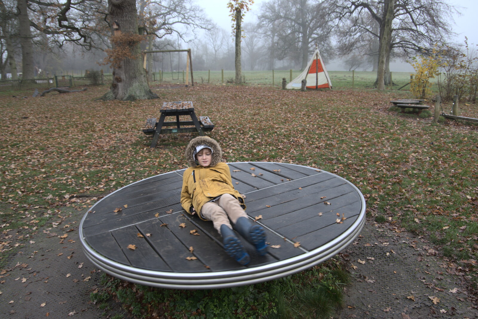 Harry has a spin around in the playground from A Return to Thornham Walks, Thornham, Suffolk - 19th December 2021