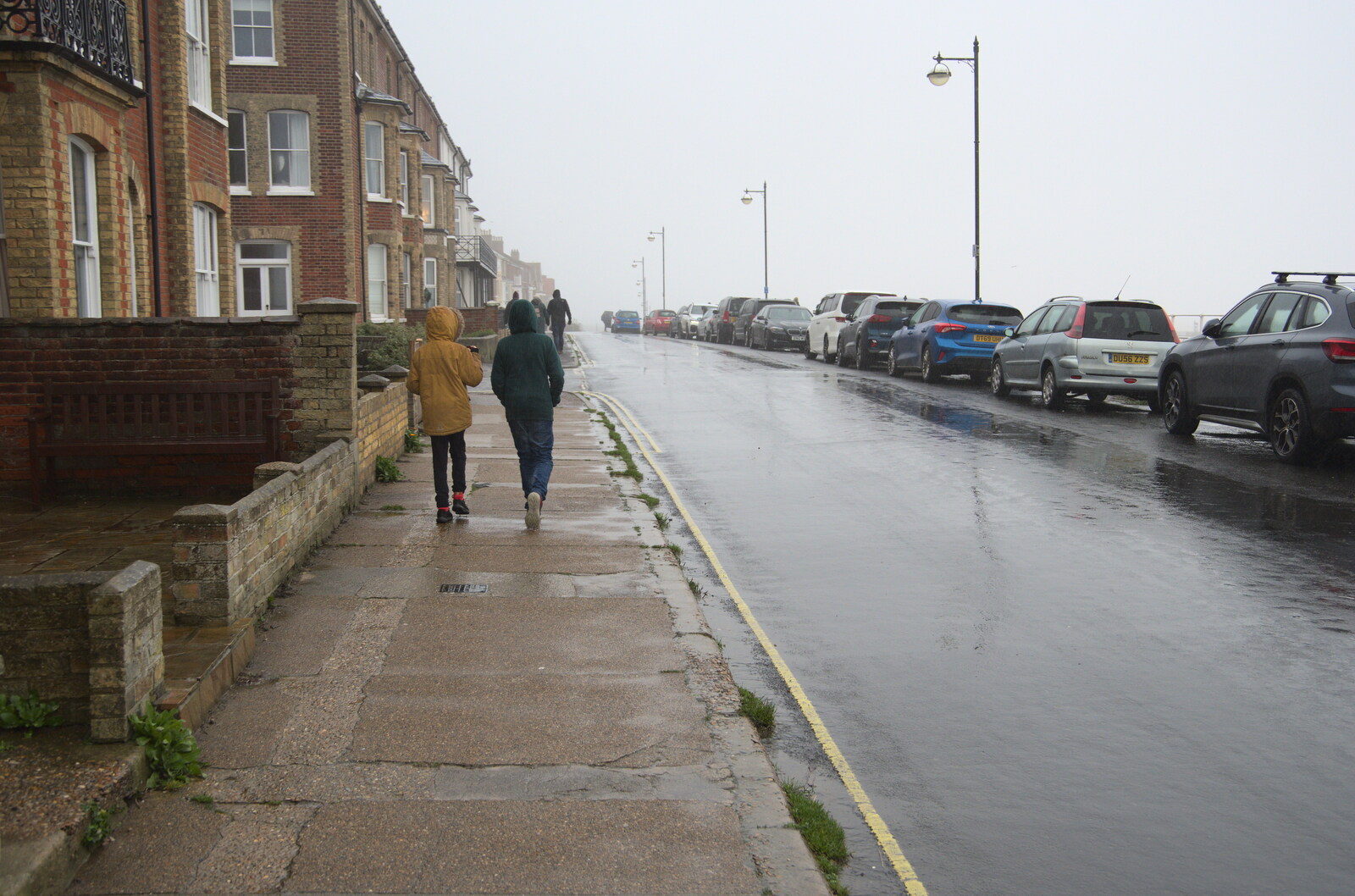 The boys walk along a wet North Parade from A Few Hours at the Seaside, Southwold, Suffolk - 27th December 2021