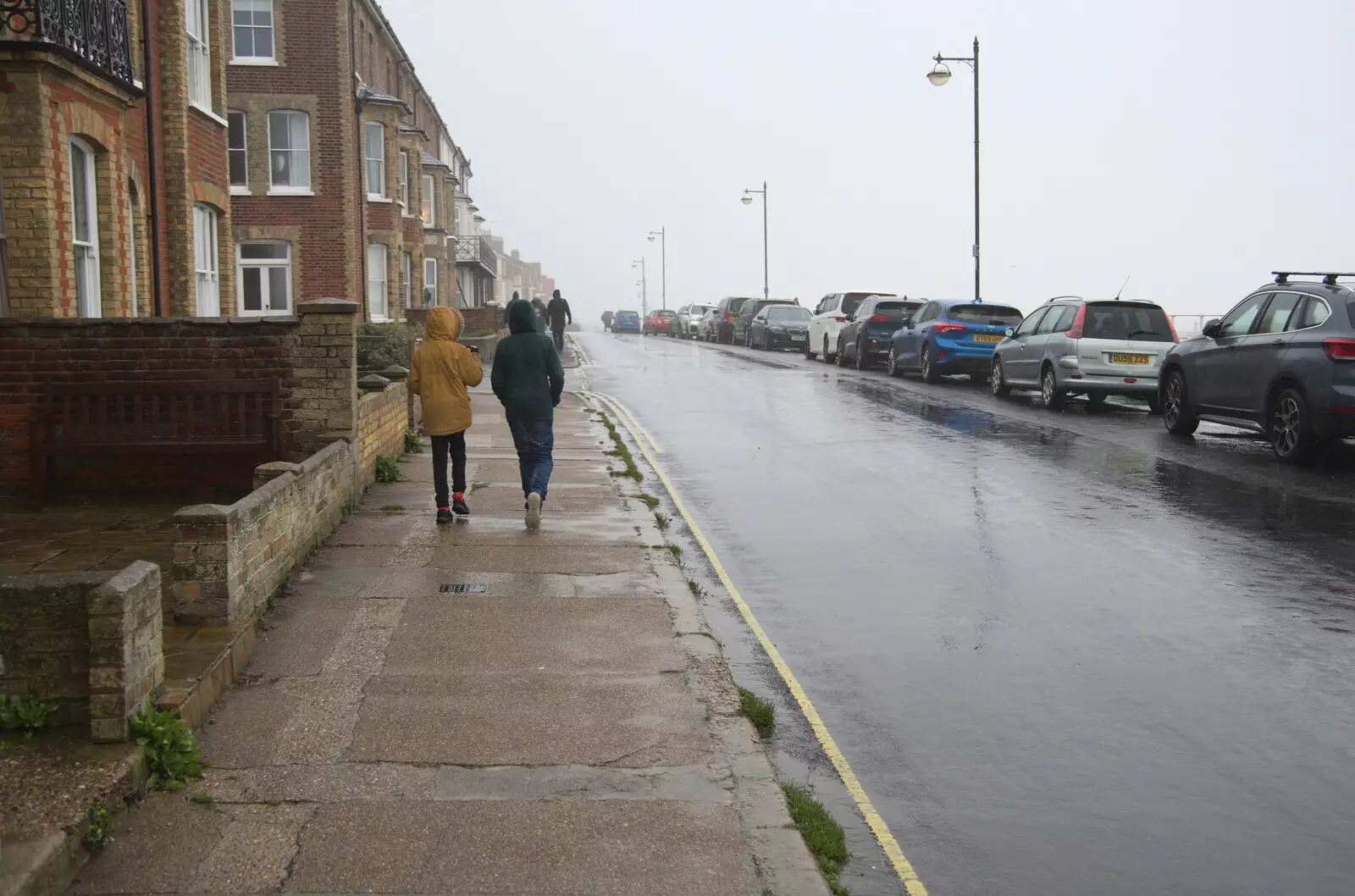 The boys walk along a wet North Parade, from A Few Hours at the Seaside, Southwold, Suffolk - 27th December 2021