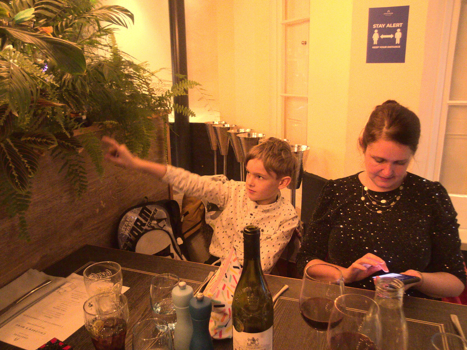Harry points at something in the fake plants from Dinner at the Oaksmere and a Ride to Eye, Suffolk - 5th January 2022