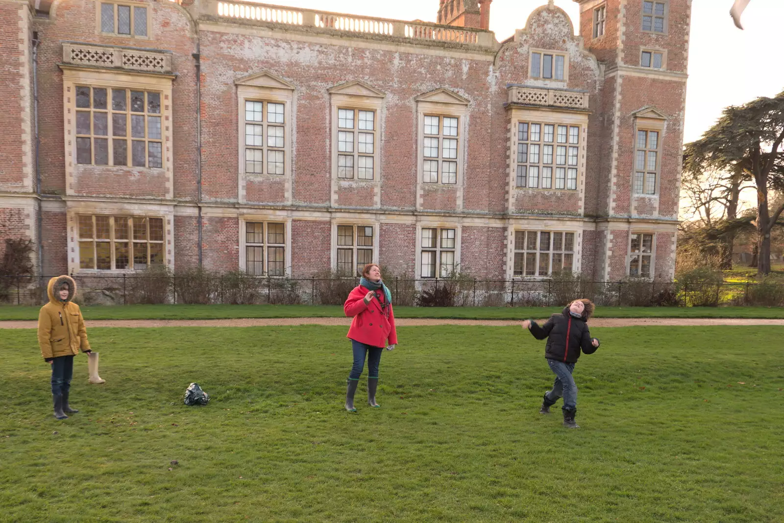 Fred lobs a wellie boot into the air, from A Visit to Blickling Hall, Aylsham, Norfolk - 9th January 2022