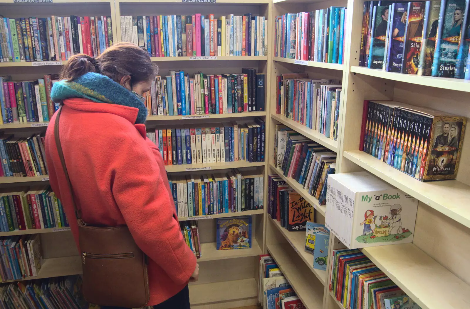 Isobel browses in the children's section, from A Visit to Blickling Hall, Aylsham, Norfolk - 9th January 2022