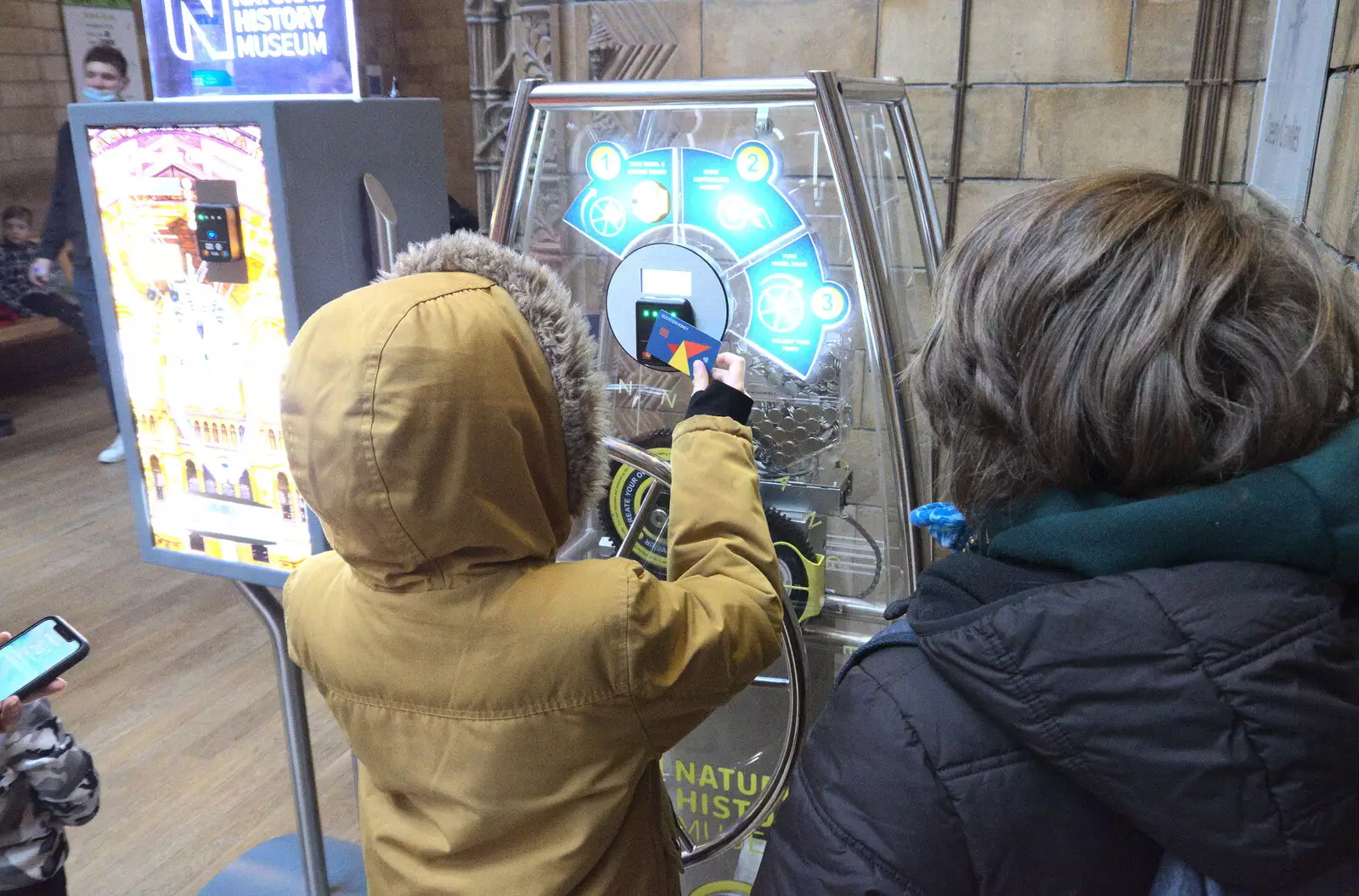 Harry gets a souvenir coin thing, from A Trip to the Natural History Museum, Kensington, London - 15th January 2022