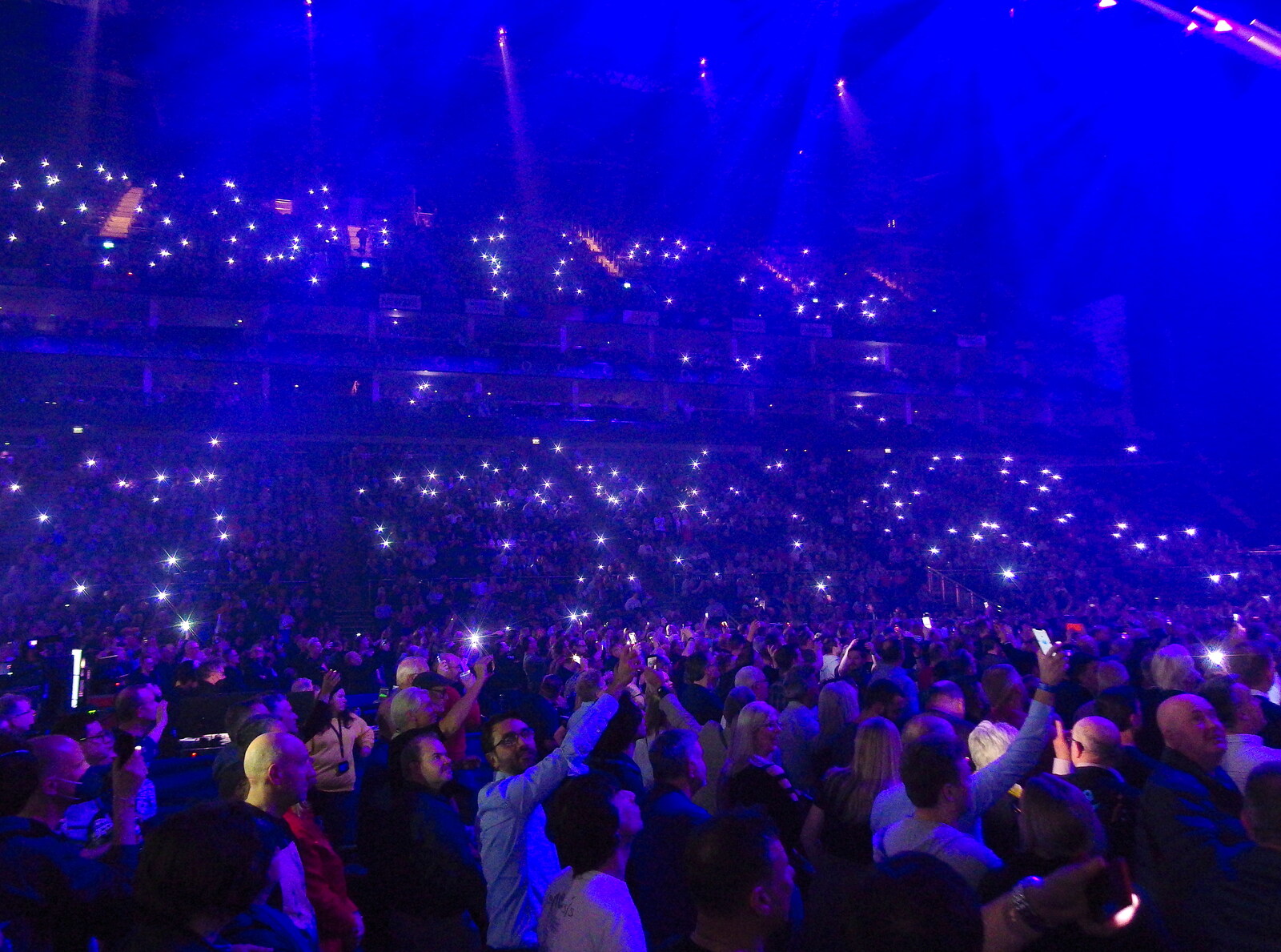 Mobile phones do the job of lighters for a torch song from Genesis at the O2, North Greenwich, London - 24th March 2022