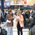 2022 A woman with a crown checks a timetable