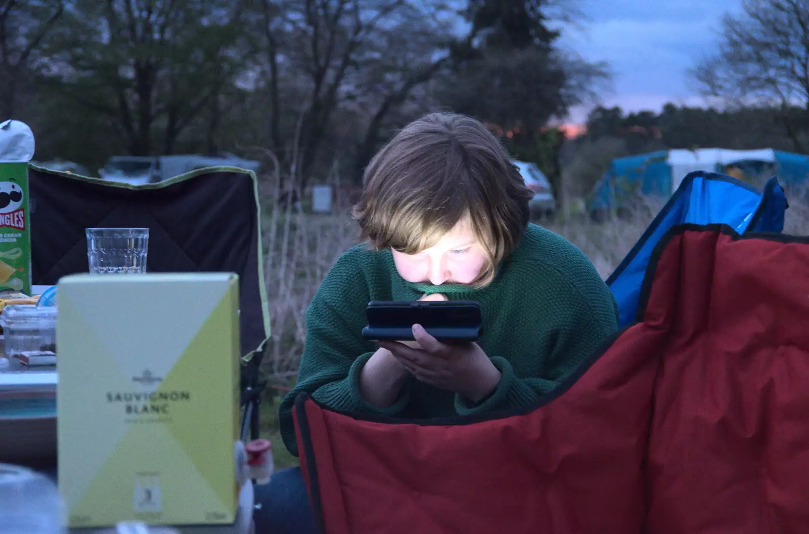 Grace looks at her phone, from A Camper-Van Trip, West Harling, Norfolk - 13th April 2022