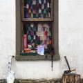 2022 A crochet blanket hangs in a window