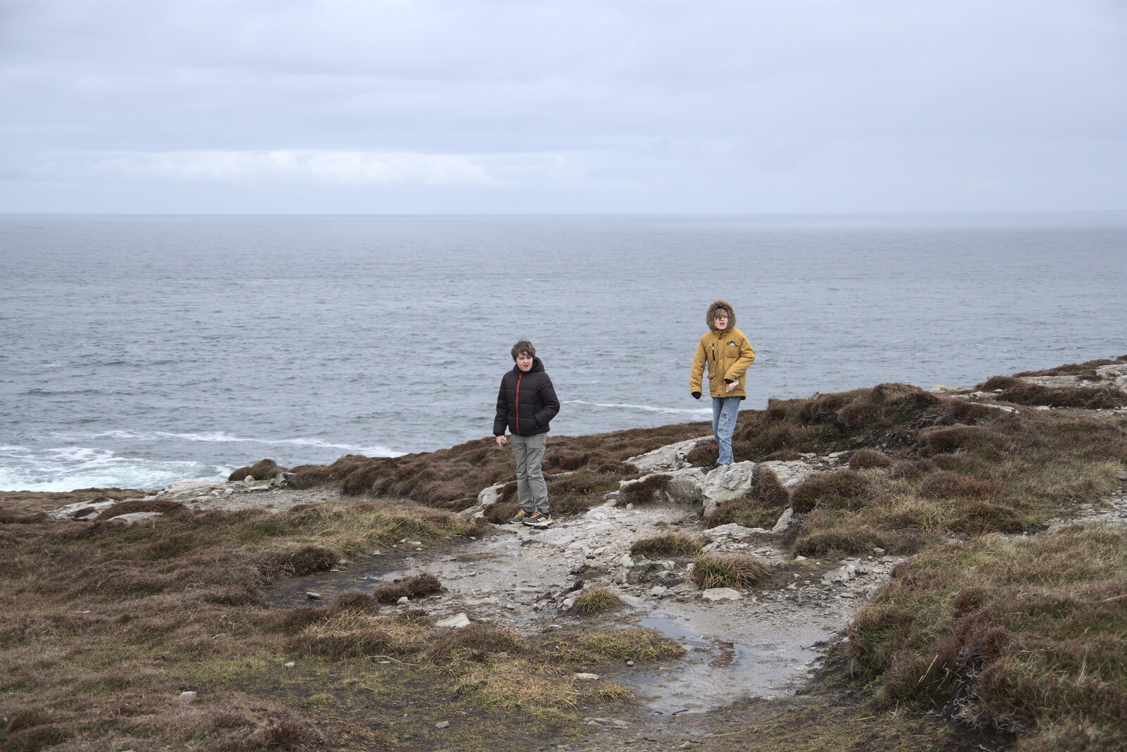 Greencastle, Doagh and Malin Head, County Donegal, Ireland - 19th April 2022: The boys on the cliff at Malin Head