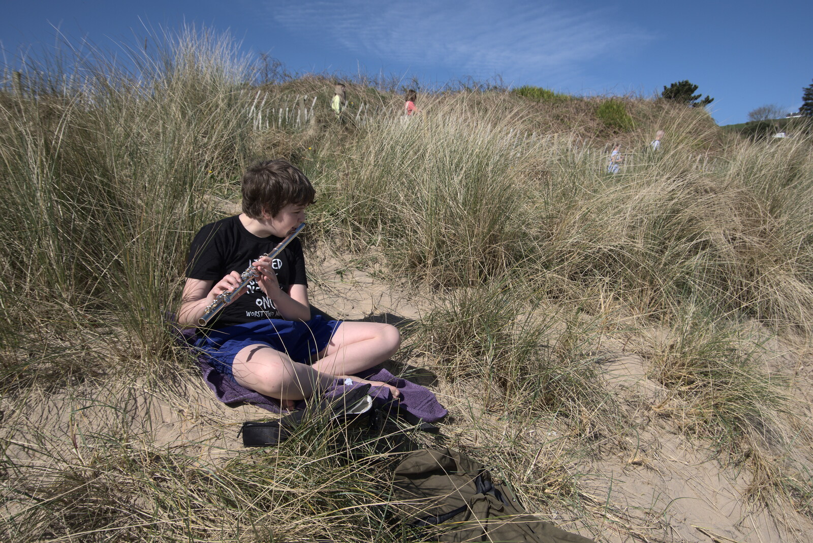 Greencastle, Doagh and Malin Head, County Donegal, Ireland - 19th April 2022: Fred plays flute in the dunes