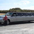 2022 Harry stands next to the stretch limo