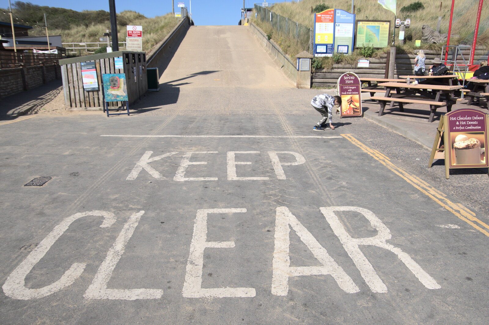 Harry picks some up near a big Keep Clear sign from On the Beach at Sea Palling, Norfolk - 8th May 2022