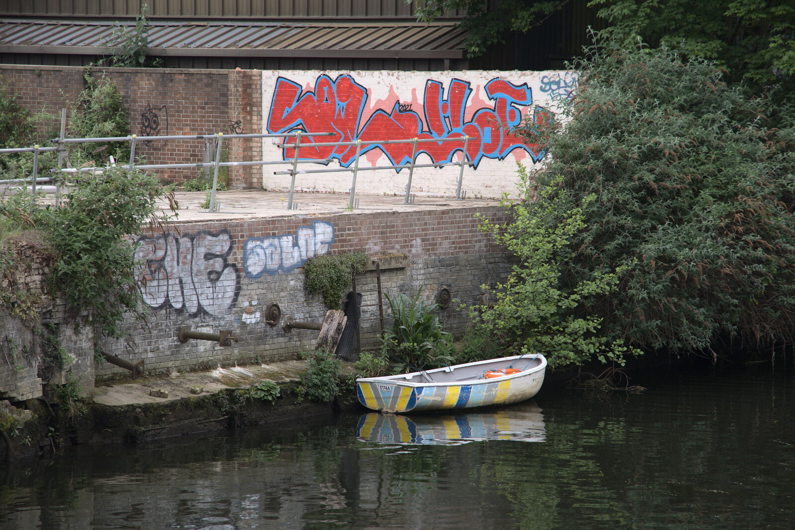 A stripey boat is moored next to some graffiti from Discovering the Hidden City: Norwich, Norfolk - 23rd May 2022