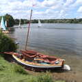 2022 There's a lovely Gunter-rig wooden dinghie moored up