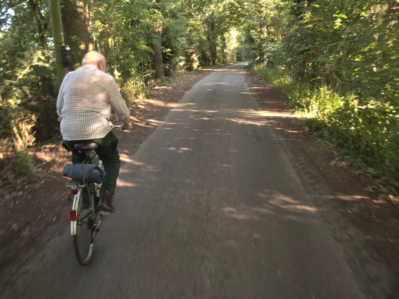 Mick the Brick cycles through Thornham Woods, from Pizza at the Village Hall, Brome, Suffolk - 24th June 2022