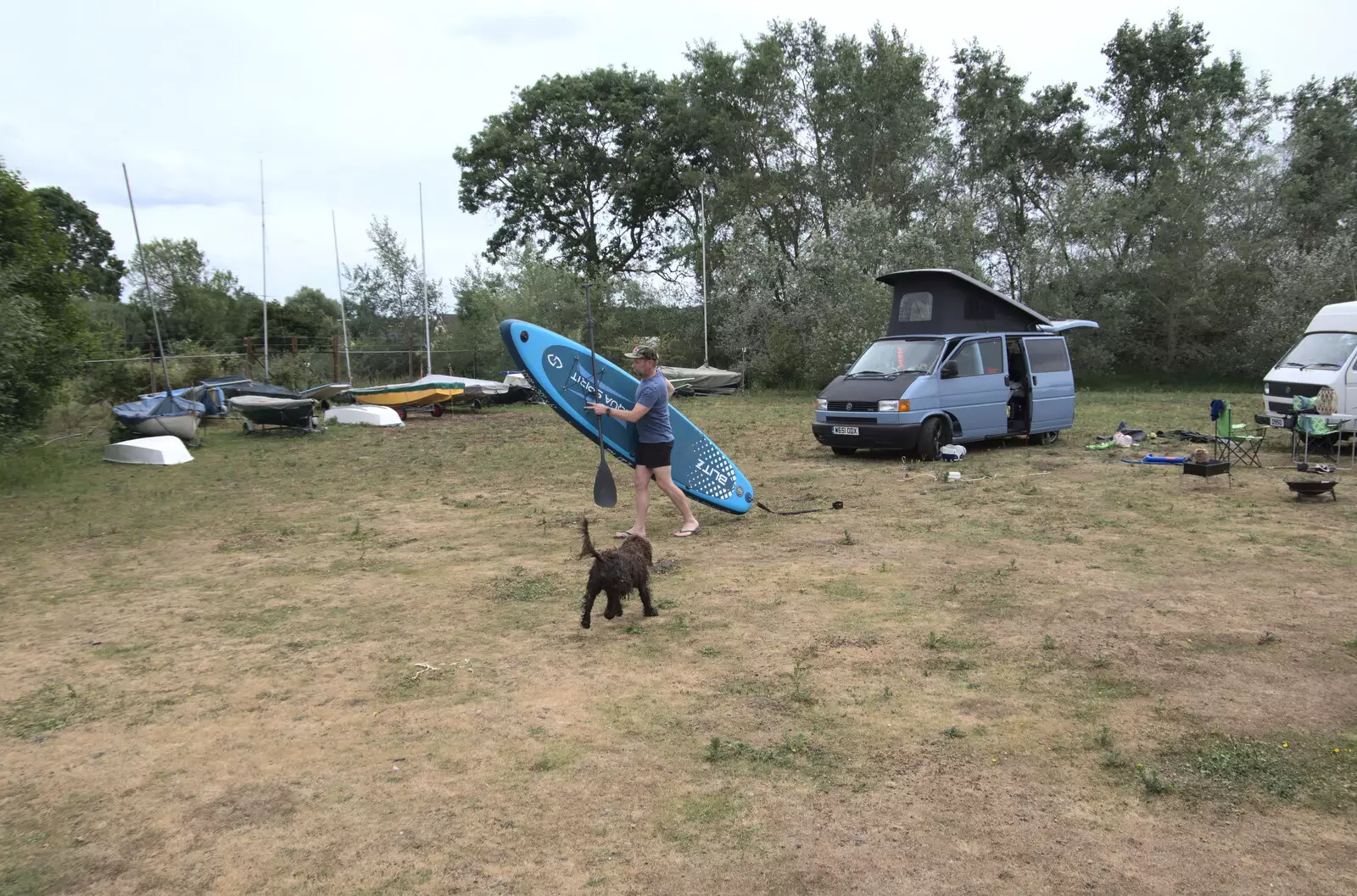 Pete carries a paddleboard down to the lake, from Camping at the Lake, Weybread, Harleston - 25th June 2022