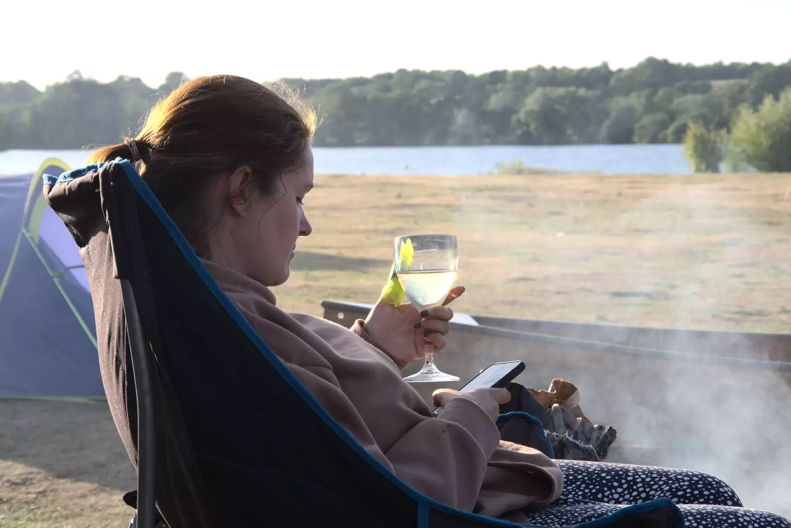 Isobel does some phone stuff, from Camping at the Lake, Weybread, Harleston - 25th June 2022