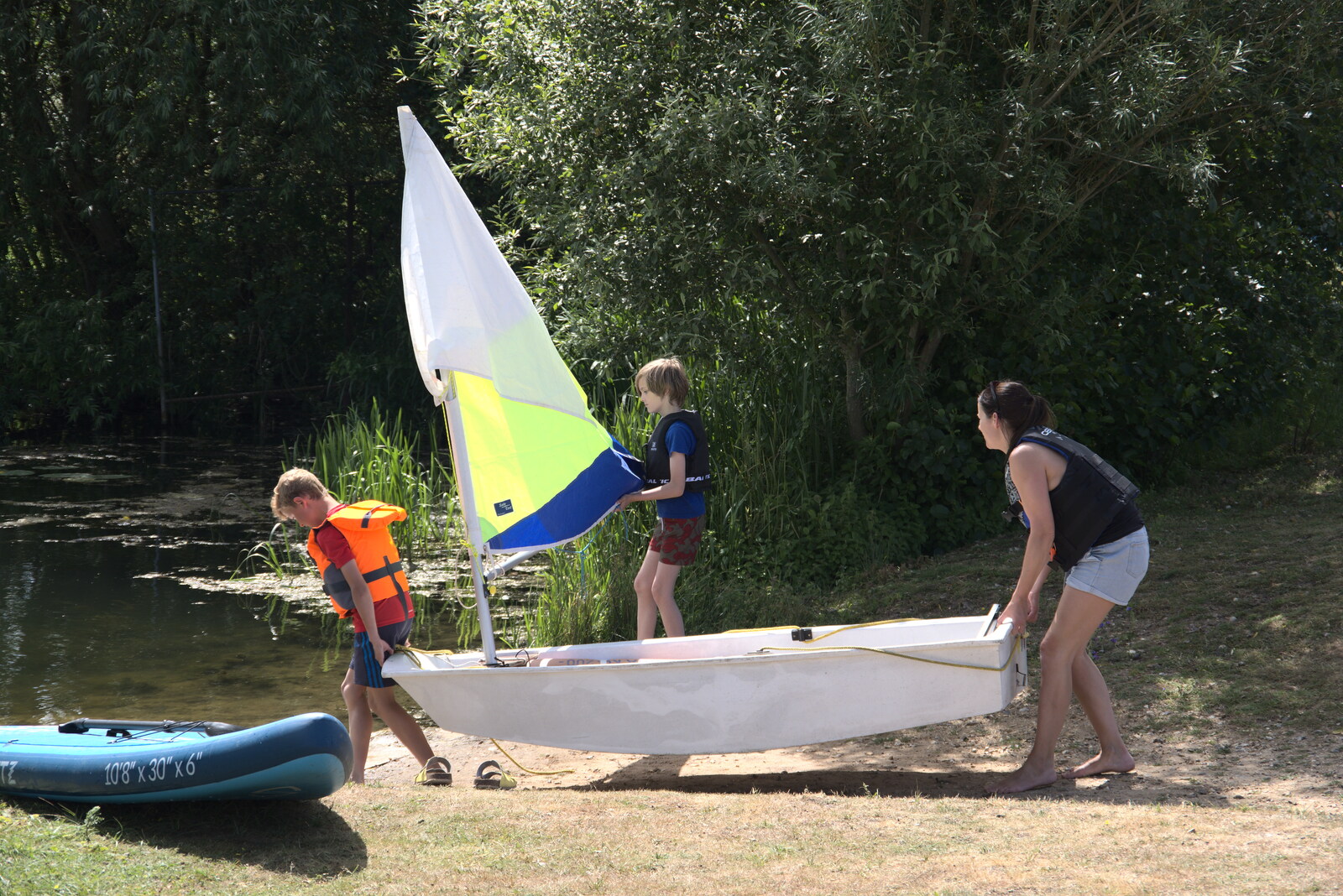 Harry helps launch a tiny dinghy from Camping at the Lake, Weybread, Harleston - 25th June 2022