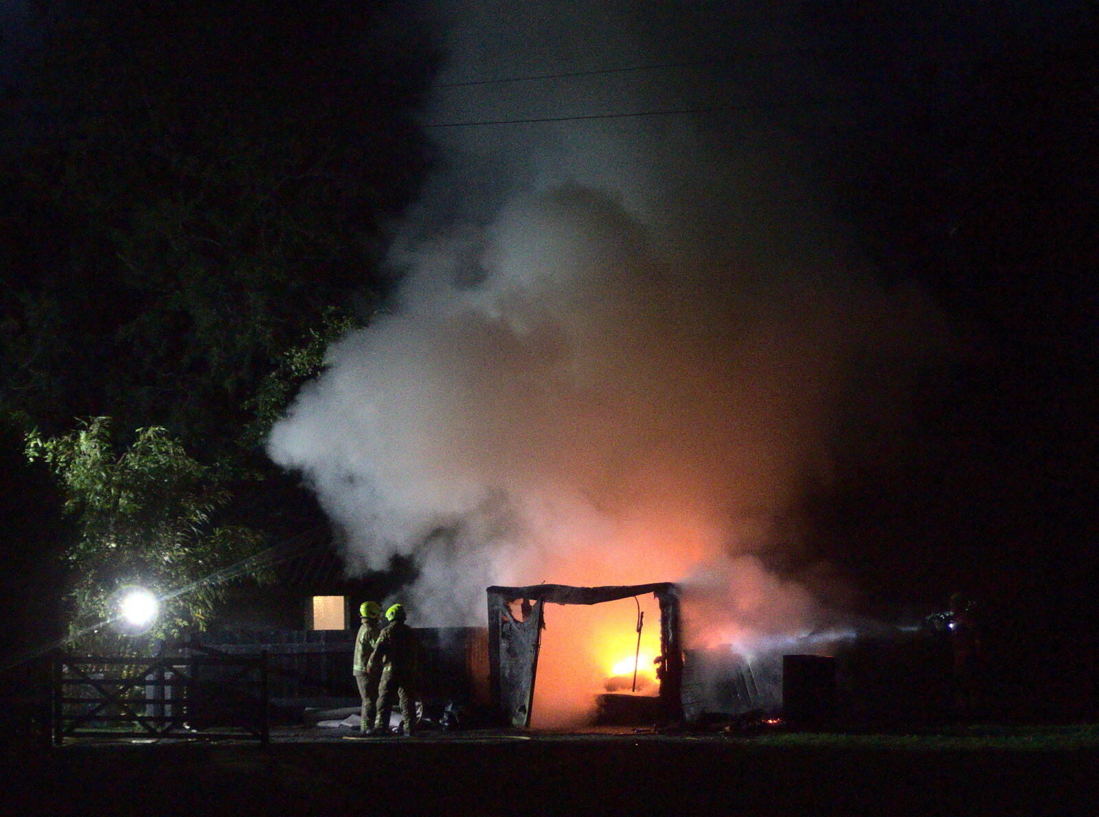 The firefighters get the shed fire under control from A Fire, a Fête, and a Scout Camp, Hallowtree, Suffolk - 30th June 2022