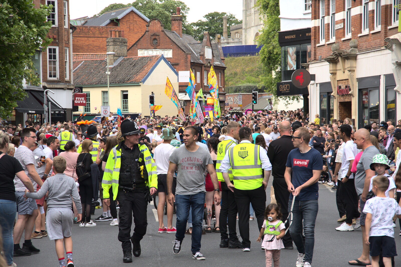 Large crowds follow the parade down the road from The Lord Mayor's Procession, Norwich, Norfolk - 2nd July 2022