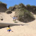 Camping in the Dunes, Waxham Sands, Norfolk - 9th July 2022, Sophie does some sand surfing