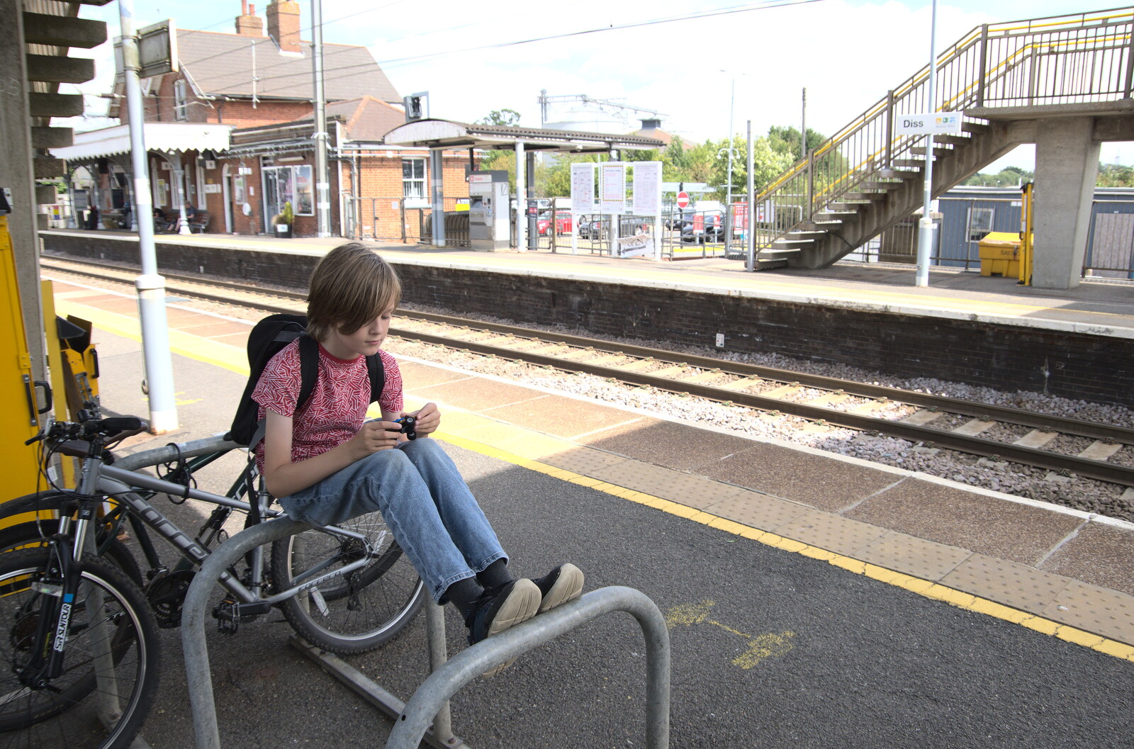 A July Miscellany, Diss, Eye and Norwich - 23rd July 2022: Harry on the bike racks as we wait for the train