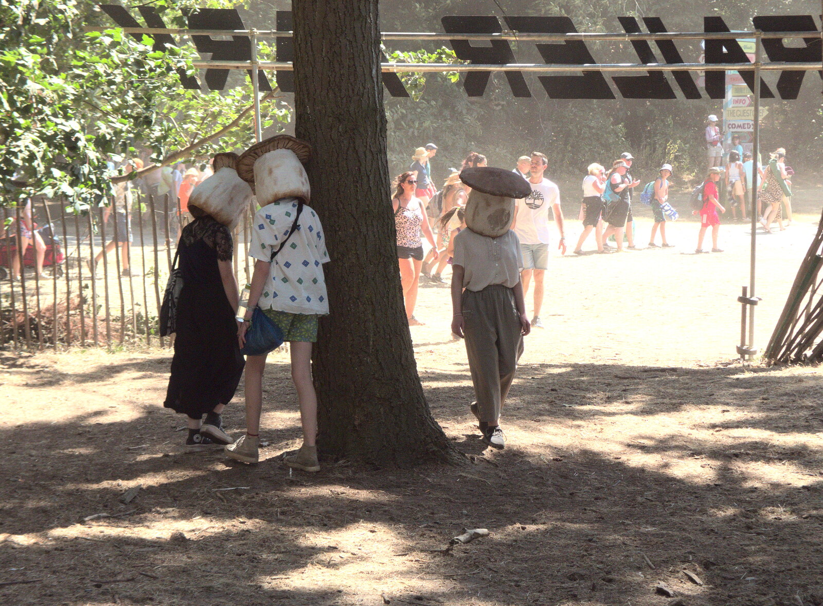 A Day at Latitude, Henham Park, Suffolk - 24th July 2022: People walk around trees with mushroom heads