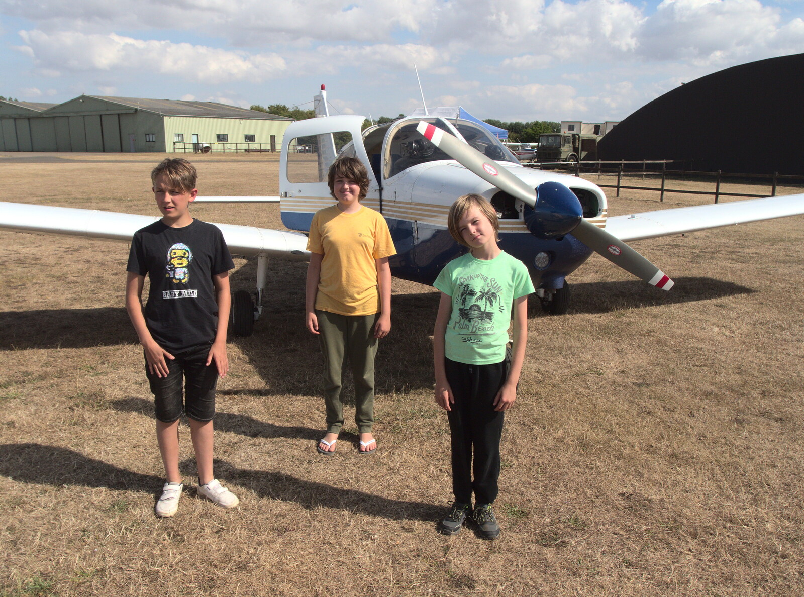 The boys pose for a photo in front of the Piper from A Trip to Old Buckenham Airfield, Norfolk - 6th August 2022