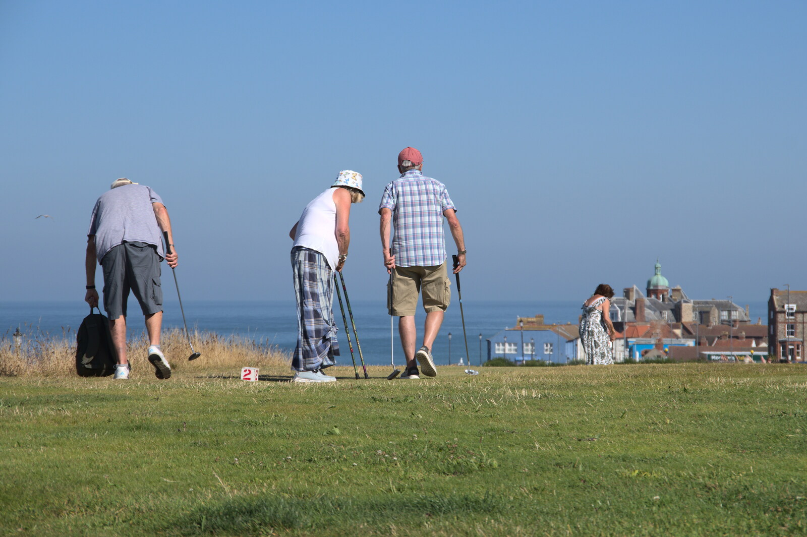 Old dudes play pitch-and-putt on the clifftop from Camping at Forest Park, Cromer, Norfolk - 12th August 2022