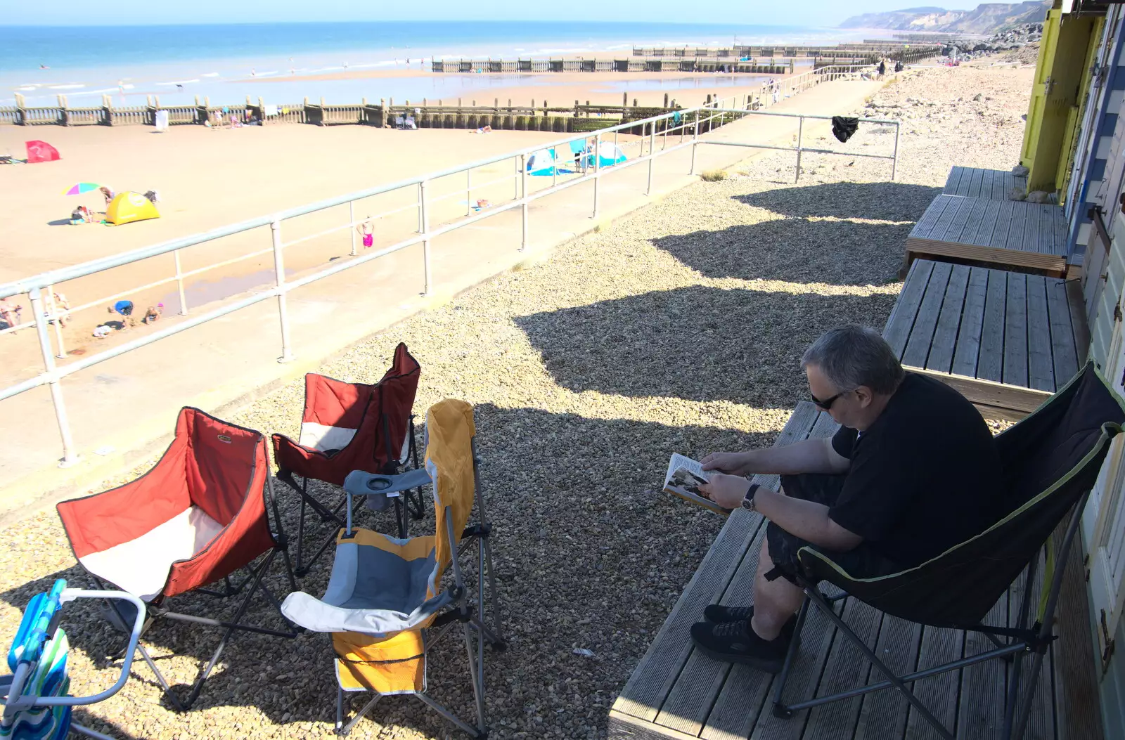 Chris reads a book, from Camping at Forest Park, Cromer, Norfolk - 12th August 2022