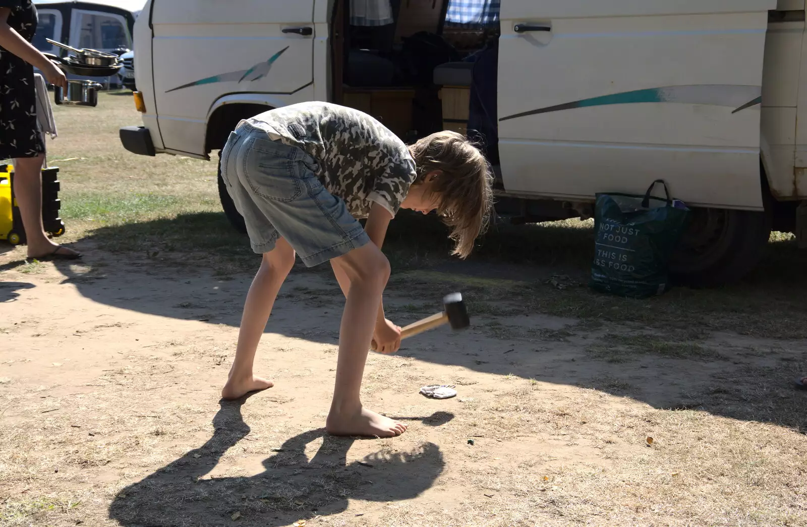 Harry 'helps' by bashing up an empty can, from Camping at Forest Park, Cromer, Norfolk - 12th August 2022