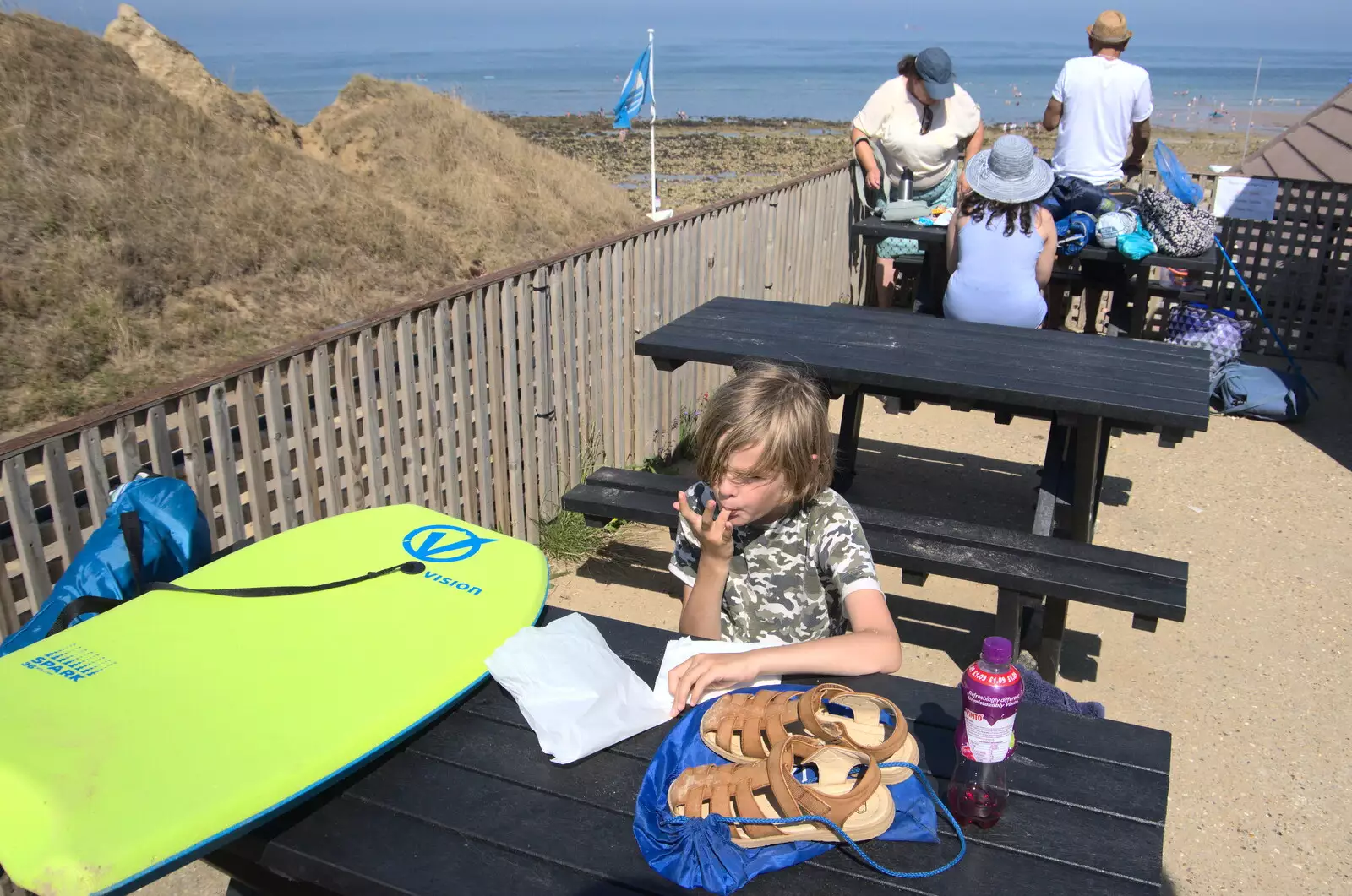 Harry licks his fingers after a bag of donuts, from Camping at Forest Park, Cromer, Norfolk - 12th August 2022