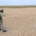A Trip to Orford Ness, Orford, Suffolk - 16th August 2022, Fred takes a photo of the cracked earth